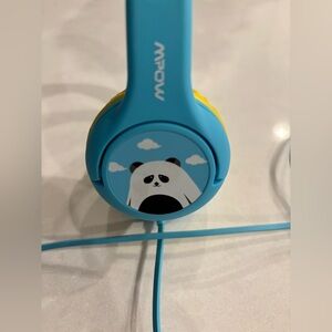 Mpow kids sized wired headphones. Blue and Yellow with a panda on each side.